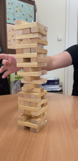 Wieża z gry "Jenga" ustawiona na stoliku.