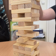 Wieża z gry "Jenga" ustawiona na stoliku.